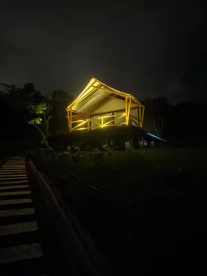 a house with a lit up roof at night at Safari Tent El Cielo in Santa Ana