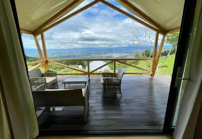 a large screened in porch with chairs and a table at Safari Tent El Cielo in Santa Ana