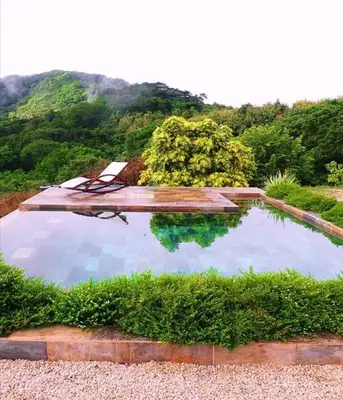 a swimming pool with a view of a mountain at Blue Sky Lodge in Nicoya