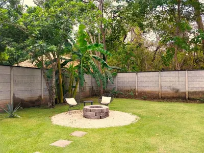 two chairs and a fire pit in a yard at Casa Mobula - Modern single-level Home, private Pool, near Beach in Potrero