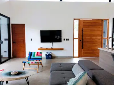 a living room with a couch and a tv at Casa Mobula - Modern single-level Home, private Pool, near Beach in Potrero