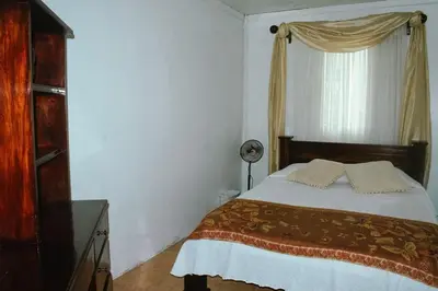 a bedroom with a bed and a window at Casa Posada Margarita in Bijagua