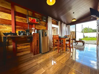 a kitchen with a refrigerator and a table with chairs at Tribu Bungalows Romantic & Confortable 2 in Fortuna