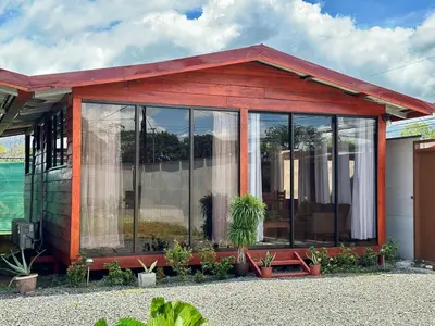 a small house with large glass windows at Tribu Bungalows Romantic & Confortable 2 in Fortuna