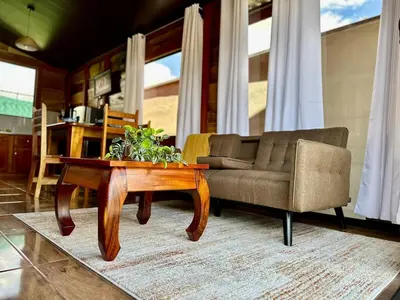 a living room with a couch and a coffee table at Tribu Bungalows Romantic & Confortable 2 in Fortuna
