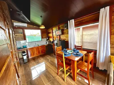 a kitchen and dining room with a table and chairs at Tribu Bungalows 3 Romantic Spot in Fortuna