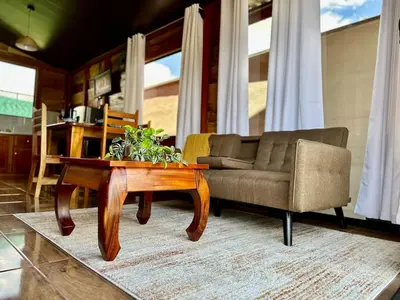 a living room with a couch and a coffee table at Tribu Bungalow 4 Centrally located and comfortable in Fortuna