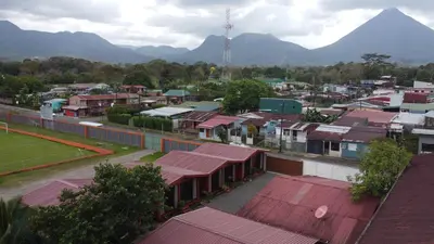 a city with houses and mountains in the background at Tribu Bungalow 4 Centrally located and comfortable in Fortuna