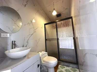 a bathroom with a sink and a toilet and a mirror at Tribu Bungalows 5 Nice Interior Design in Fortuna