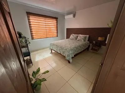 a bedroom with a bed and a window at Nature Heaven in Jabillos