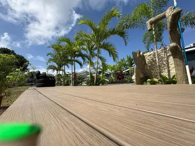 a wooden floor with palm trees in the background at Nature Heaven in Jabillos
