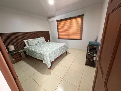 a bedroom with a bed and a window at Nature Heaven in Jabillos