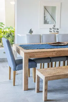 a dining room table with blue chairs and a mirror at Oceanview 3BR Villa with 3 Shared Pools and Beachfront Resort Access in Ocotal