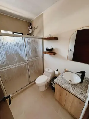 a bathroom with a toilet and a sink at Namú Apartment in Herradura