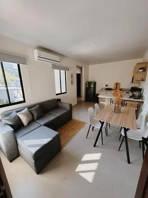 a living room with a couch and a table at Namú Apartment in Herradura
