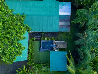an overhead view of a house with a pool and trees at ParadiseTropical Garden Cabin with private jacuzzi in Fortuna