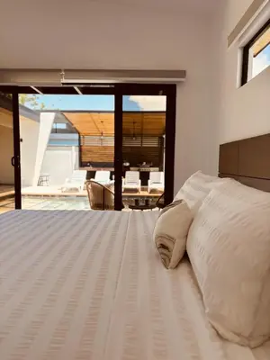 a bedroom with a bed with a view of a patio at Casa Morfa in Uvita