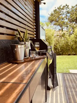 a grill with glasses of wine on a deck at Casa Morfa in Uvita