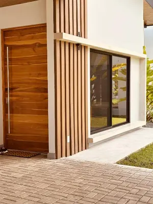 a wooden door on the side of a house at Casa Morfa in Uvita