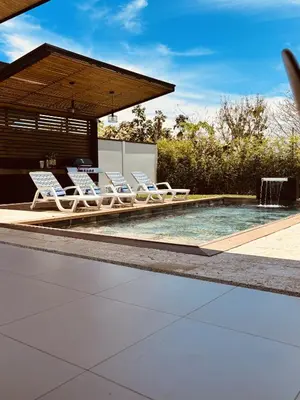 a group of lounge chairs sitting next to a swimming pool at Casa Morfa in Uvita