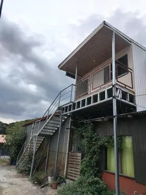a house with a staircase on the side of it at Apartamento Roble Sabana in Tapantí