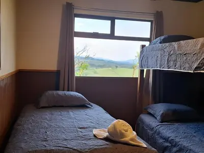 a bedroom with two bunk beds and a window at Casa Vacacional floreva in Tapantí