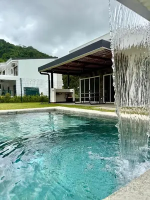 a swimming pool with a water fountain at Casa kai in Agujas