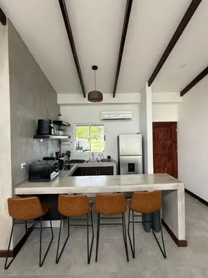 a large kitchen with a large table and chairs at Casa kai in Agujas