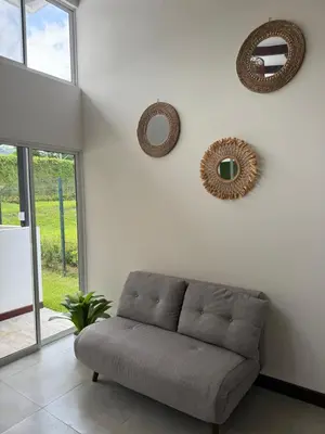 a living room with a couch and mirrors on the wall at Casa kai in Agujas