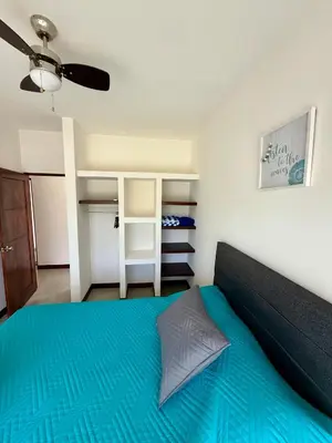 a bedroom with a blue bed and a closet at Casa kai in Agujas