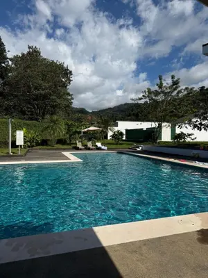 a large swimming pool with blue water at Casa kai in Agujas