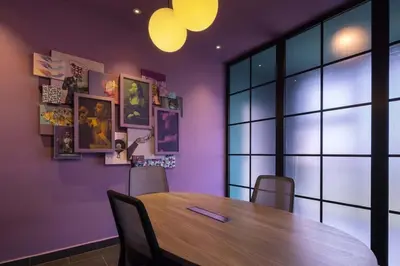 a dining room with a wooden table and purple walls at Unique Industrial Apt Near Airport in La Sabana in San José