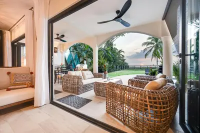 a living room with a large glass door leading to a patio at Beachfront2 bed 2 bathPortreroFlamigo-Marina in Playa Flamingo