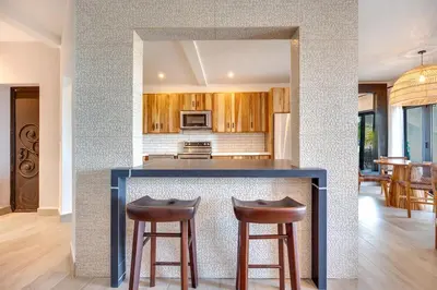 a kitchen with a counter and two bar stools at Beachfront2 bed 2 bathPortreroFlamigo-Marina in Playa Flamingo