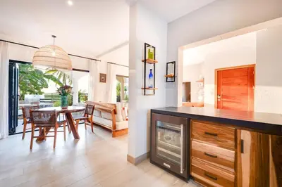 a kitchen and dining room with a table and chairs at Beachfront2 bed 2 bathPortreroFlamigo-Marina in Playa Flamingo
