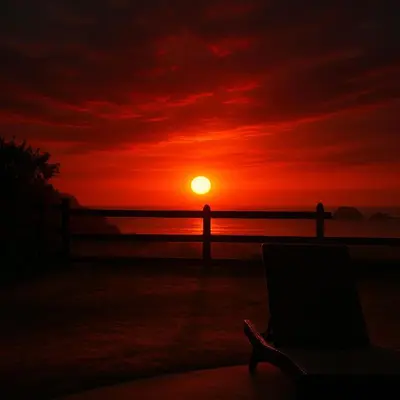 a sunset with a chair in front of a fence at Beachfront2 bed 2 bathPortreroFlamigo-Marina in Playa Flamingo