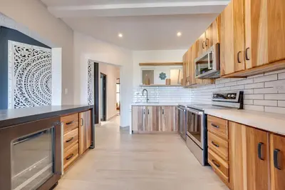 a large kitchen with wooden cabinets and counters at Beachfront2 bed 2 bathPortreroFlamigo-Marina in Playa Flamingo