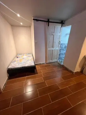 a room with a bed in the corner of a room at BAyRA Homes in Alajuela City