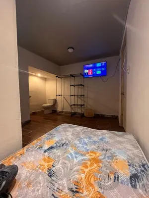 a room with a bed and a tv on the wall at BAyRA Homes in Alajuela City