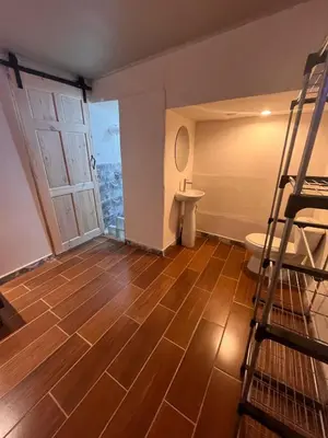 a bathroom with a ladder and a toilet in a room at BAyRA Homes in Alajuela City
