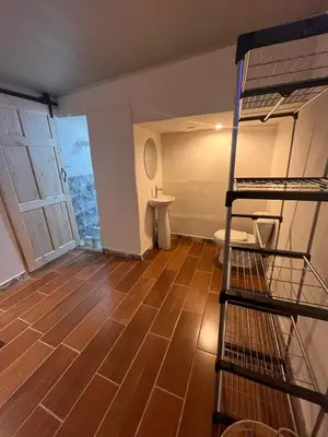 a room with a bunk bed and a bathroom at BAyRA Homes in Alajuela City