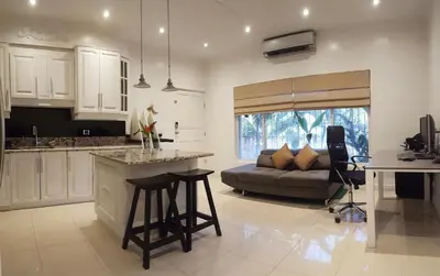 a kitchen and a living room with a couch at Condo Niko - Centrally Located, Steps to Beach! in Tamarindo