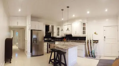 a kitchen with white cabinets and a counter top at Condo Niko - Centrally Located, Steps to Beach! in Tamarindo