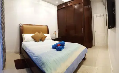 a bedroom with a bed with a stuffed animal on it at Condo Niko - Centrally Located, Steps to Beach! in Tamarindo