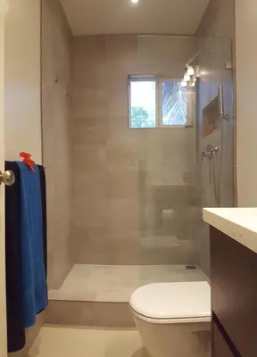 a bathroom with a shower with a toilet and a sink at Condo Niko - Centrally Located, Steps to Beach! in Tamarindo