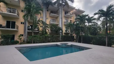 a swimming pool in front of a building at Condo Popeye - Cute condo in the heart of Tama! in Tamarindo