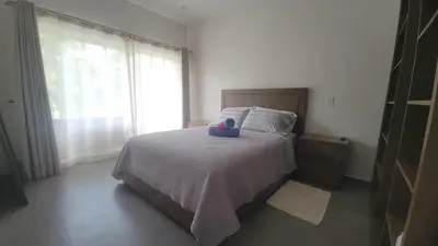 a bedroom with a bed with a stuffed animal on it at Condo Popeye - Cute condo in the heart of Tama! in Tamarindo