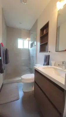 a bathroom with a toilet and a sink and a shower at Condo Popeye - Cute condo in the heart of Tama! in Tamarindo