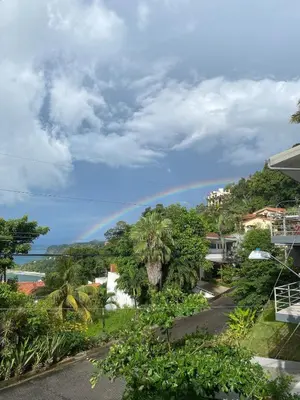 a rainbow in the sky over a city at Apartment 4 personas, full equipado, Santa ana , San Jose Costa Rica in Isla Herradura