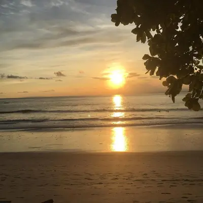 a sunset on a beach with the ocean at Apartment 4 personas, full equipado, Santa ana , San Jose Costa Rica in Isla Herradura